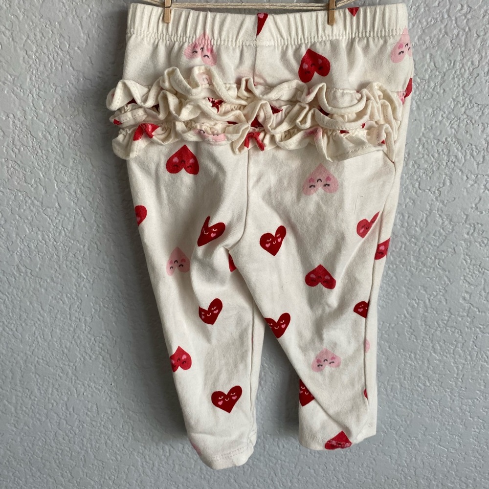Off-white colored pants with hearts